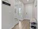 Bright entryway featuring wood floors, a mirror, and white accents offers a modern, clean aesthetic at 2168 Aibonito Cir, Clermont, FL 34711
