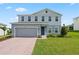 Attractive two-story home with brick driveway and lush lawn, offers an appealing suburban lifestyle at 2168 Aibonito Cir, Clermont, FL 34711