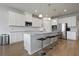 Modern kitchen featuring white cabinets, stainless steel appliances, and a large center island with barstool seating at 2168 Aibonito Cir, Clermont, FL 34711