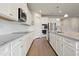 Bright kitchen features white cabinets, subway tile backsplash, granite countertops and stainless steel appliances at 2168 Aibonito Cir, Clermont, FL 34711