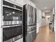 Stainless steel appliances, including a double oven and refrigerator, are a highlight of this bright, modern kitchen at 2168 Aibonito Cir, Clermont, FL 34711
