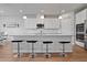 Modern kitchen features white cabinets, granite countertops, stainless steel appliances, and bar seating at 2168 Aibonito Cir, Clermont, FL 34711