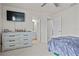 Bright main bedroom featuring neutral colors, a large dresser, and a ceiling fan at 2168 Aibonito Cir, Clermont, FL 34711