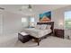 Comfortable main bedroom with natural light, bed, and bedside tables at 2168 Aibonito Cir, Clermont, FL 34711