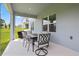 Outdoor dining set on a covered patio with a grill at 2168 Aibonito Cir, Clermont, FL 34711