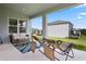 Covered patio with comfortable seating and a view of the spacious backyard at 2168 Aibonito Cir, Clermont, FL 34711