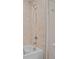 Close-up of a shower with beige tiles, a shower head, and chrome hardware at 2168 Aibonito Cir, Clermont, FL 34711