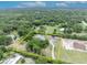 Aerial view of the property showcasing a long driveway and surrounding area at 2459 Mcgregor Oaks Ln, Deland, FL 32720