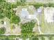 Aerial view of the property showcasing the pool, outbuildings, and landscape at 2459 Mcgregor Oaks Ln, Deland, FL 32720