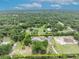 An aerial view showing the property lines highlighted in yellow at 2459 Mcgregor Oaks Ln, Deland, FL 32720