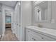 Modern bathroom featuring a sleek vanity, sink, and a view into the hall at 2459 Mcgregor Oaks Ln, Deland, FL 32720