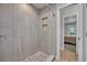 Modern bathroom featuring a walk-in shower with stylish tile and a built-in niche at 2459 Mcgregor Oaks Ln, Deland, FL 32720