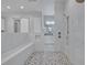 Modern bathroom with a walk-in shower, a built-in seat, and mosaic tile floor at 2459 Mcgregor Oaks Ln, Deland, FL 32720