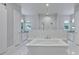 Luxurious bathroom featuring a soaking tub and walk-in shower with rainfall head at 2459 Mcgregor Oaks Ln, Deland, FL 32720