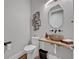 Contemporary powder room featuring a vessel sink, unique mirror, and modern fixtures at 2459 Mcgregor Oaks Ln, Deland, FL 32720
