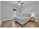 Cozy bedroom with hardwood floors, a ceiling fan, and window at 2459 Mcgregor Oaks Ln, Deland, FL 32720