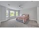 Comfortable bedroom with bay windows, ceiling fan, and soft carpeting at 2459 Mcgregor Oaks Ln, Deland, FL 32720