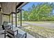 Comfortable seating overlooks the long, crushed-stone driveway winding through the trees at 2459 Mcgregor Oaks Ln, Deland, FL 32720