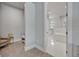 Hallway view to the bright, modern bathroom featuring a soaking tub and tile flooring at 2459 Mcgregor Oaks Ln, Deland, FL 32720