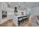 Open kitchen featuring a large island, stainless steel appliances and modern pendant lighting at 2459 Mcgregor Oaks Ln, Deland, FL 32720