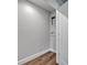Utility connections await in this laundry room, featuring base trim and wood-look vinyl flooring at 2459 Mcgregor Oaks Ln, Deland, FL 32720