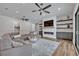 An open-concept living room with a modern fireplace, recessed lighting, and ample seating at 2459 Mcgregor Oaks Ln, Deland, FL 32720