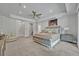 Spacious main bedroom features a seating area, ceiling fan, and ensuite bathroom at 2459 Mcgregor Oaks Ln, Deland, FL 32720