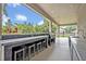 Elegant outdoor kitchen with seating, sink, and grill, perfect for entertaining at 2459 Mcgregor Oaks Ln, Deland, FL 32720