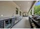 Outdoor kitchen features a sink, beverage cooler, stainless drawers, and built-in grill at 2459 Mcgregor Oaks Ln, Deland, FL 32720