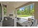Covered outdoor living space with fireplace and seating at 2459 Mcgregor Oaks Ln, Deland, FL 32720
