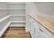 Pantry featuring custom shelving, laminate floors, and countertop space to keep you organized at 2459 Mcgregor Oaks Ln, Deland, FL 32720