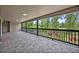 Long covered patio with tiled floor and outdoor view at 2459 Mcgregor Oaks Ln, Deland, FL 32720