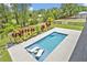 Aerial view of rectangular pool with in-pool lounge chairs and lush landscaping at 2459 Mcgregor Oaks Ln, Deland, FL 32720