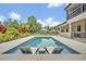 Rectangular backyard pool with in-pool lounge chairs at 2459 Mcgregor Oaks Ln, Deland, FL 32720