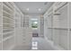 Spacious walk-in closet featuring custom shelving and a window for natural light at 2459 Mcgregor Oaks Ln, Deland, FL 32720
