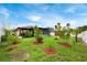 A spacious backyard with lush grass and neatly arranged mulch beds around saplings at 2625 Eagle Cliff Dr, Kissimmee, FL 34746