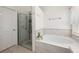 Bright bathroom featuring a glass enclosed shower and a garden tub at 2625 Eagle Cliff Dr, Kissimmee, FL 34746