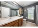 Well-lit bathroom with gray walls featuring a white sink and toilet at 2625 Eagle Cliff Dr, Kissimmee, FL 34746