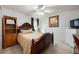 Bedroom featuring tile flooring, a ceiling fan and a large bed at 2625 Eagle Cliff Dr, Kissimmee, FL 34746