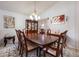 Formal dining room featuring a large wooden table, elegant decor, and ample natural light at 2625 Eagle Cliff Dr, Kissimmee, FL 34746
