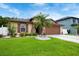 Charming single-story home featuring a well-manicured lawn and a lovely palm tree in the front yard at 2625 Eagle Cliff Dr, Kissimmee, FL 34746