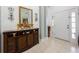 Inviting foyer showcases tiled flooring and a decorative console table with ornate mirror and candle display at 2625 Eagle Cliff Dr, Kissimmee, FL 34746