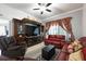 Comfortable living room featuring leather seating, a large entertainment center, and stylish decor at 2625 Eagle Cliff Dr, Kissimmee, FL 34746
