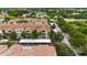 Aerial view of the condominium complex featuring well-maintained landscaping, parking, and red tile roofs at 3000 Laurel Park Ln # 308, Kissimmee, FL 34741