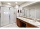 A bathroom featuring double sinks, tile flooring and a glass shower stall at 3000 Laurel Park Ln # 308, Kissimmee, FL 34741