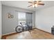 Bedroom featuring a ceiling fan, bike, a window with curtain and tile floors at 3000 Laurel Park Ln # 308, Kissimmee, FL 34741