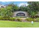 Flora Ridge Condominiums community sign surrounded by lush tropical landscaping and green grass at 3000 Laurel Park Ln # 308, Kissimmee, FL 34741