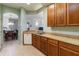 A kitchen with wooden cabinets, tile flooring and an open floorplan to the dining area at 3000 Laurel Park Ln # 308, Kissimmee, FL 34741