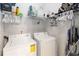 A laundry room featuring a washer, dryer and wire shelving storage at 3000 Laurel Park Ln # 308, Kissimmee, FL 34741
