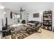 A view of the living room offering tile floors, overhead fan and light, comfortable furniture, and bright natural light at 3000 Laurel Park Ln # 308, Kissimmee, FL 34741